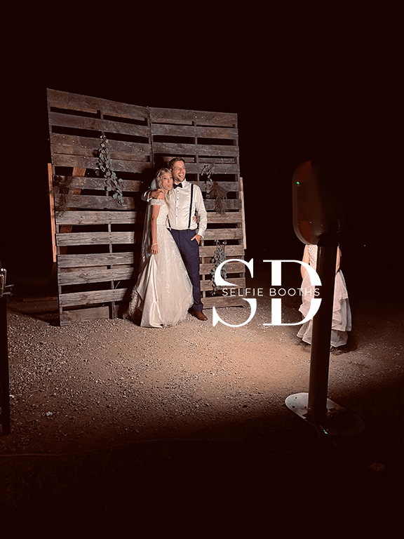 SD Selfie Booth wooden booth at an outdoor event at night