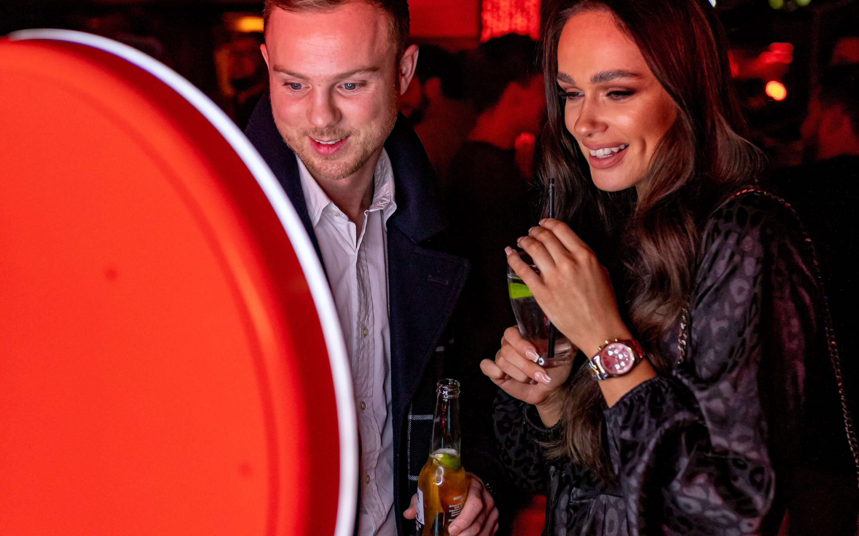 Holiday party guests posing at a branded San Diego selfie booth