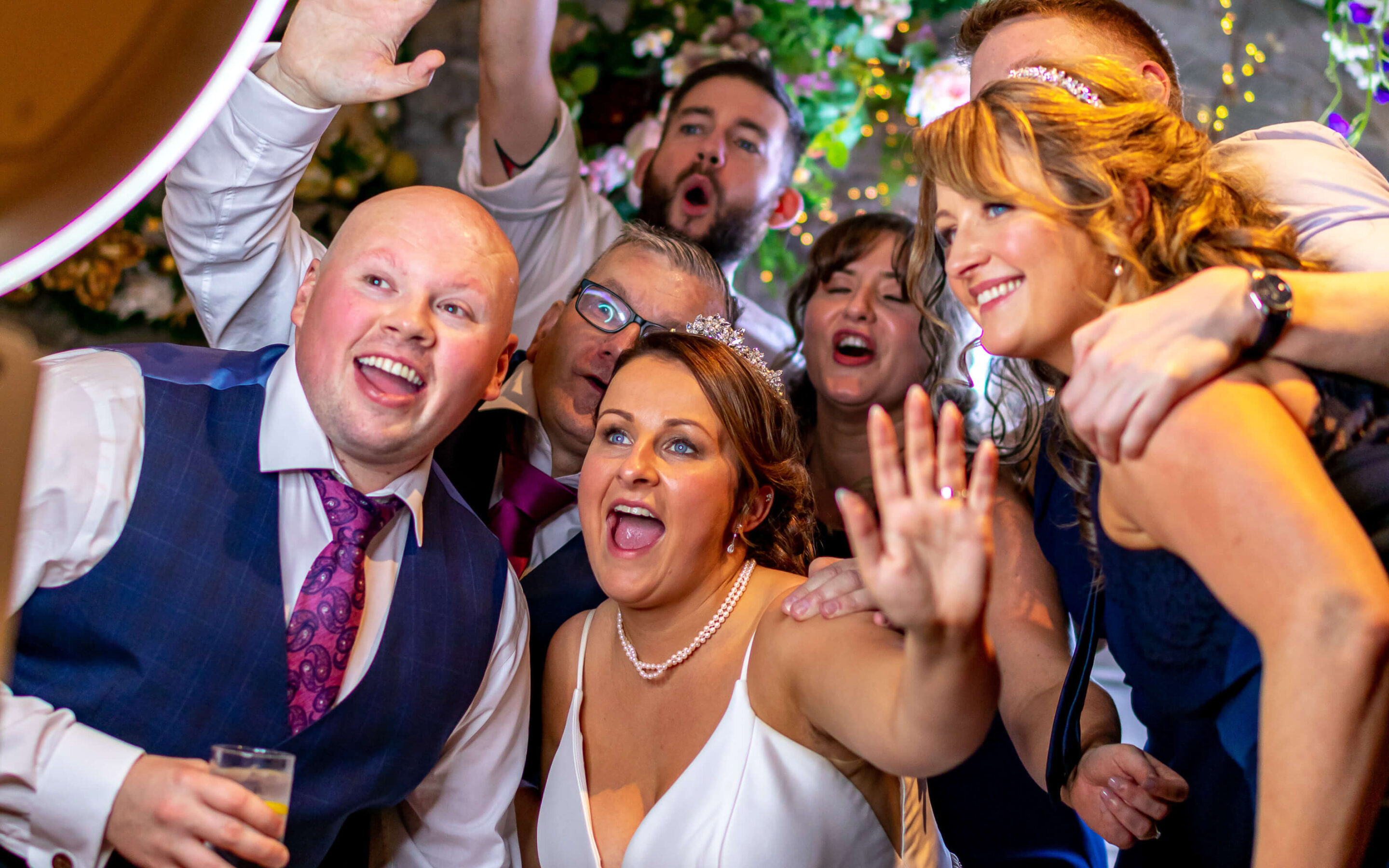 Bride and her friends laughing and cheering at a San Diego wedding photo booth